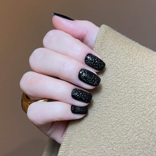Black nails with a unique bubble texture, adding a playful and tactile 3D effect to the manicure.