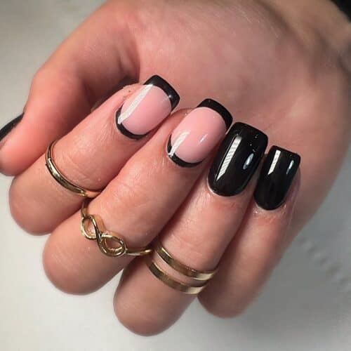 Glossy black French tips with a soft pink base and a shiny finish.