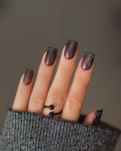 Dark square black nails with a subtle shimmer at the tips, evoking the quiet sparkle of a night sky.