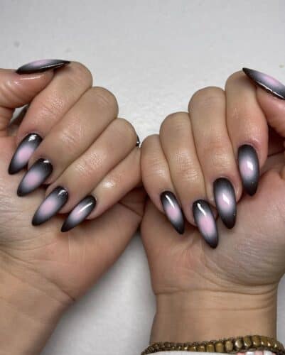Nails with a black ombre effect fading into soft pink, creating a mystical and romantic appearance.