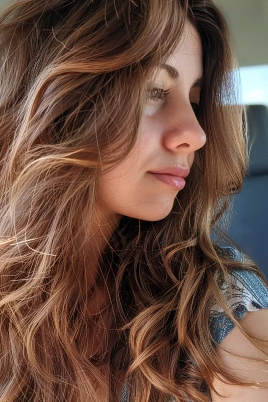 A woman with golden caramel highlights in brown hair.