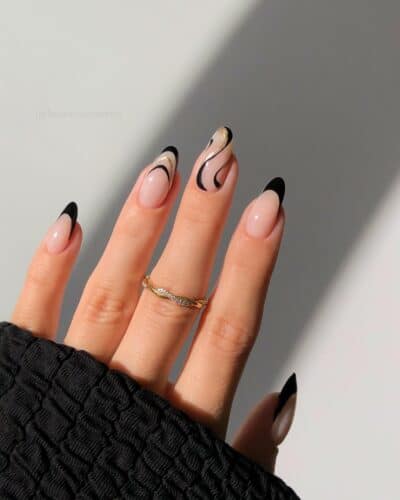 Nails featuring an abstract design with black matte, white and gold lines, creating a modern and artistic look.