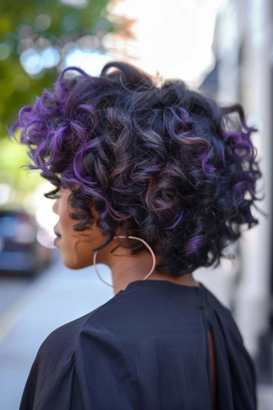 Dark brown hair with striking purple highlights adding a playful contrast.