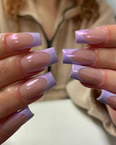 Square-shaped nails with natural glossy bases and light purple French tips.