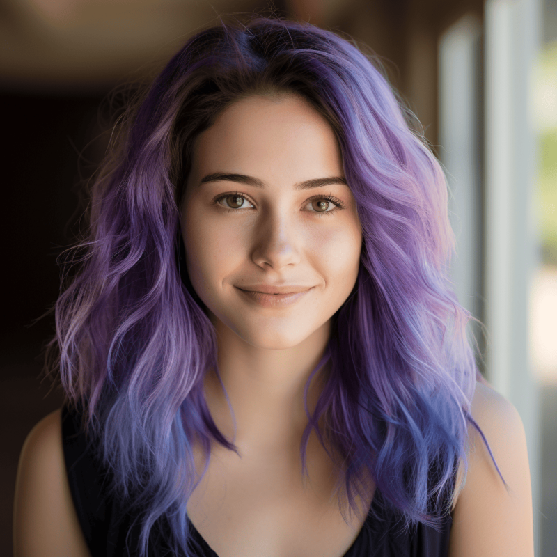 Hair with deep purple roots transitioning to vibrant blue tips.
