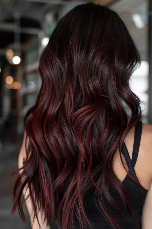 Long, curly hair in a deep chocolate red color.