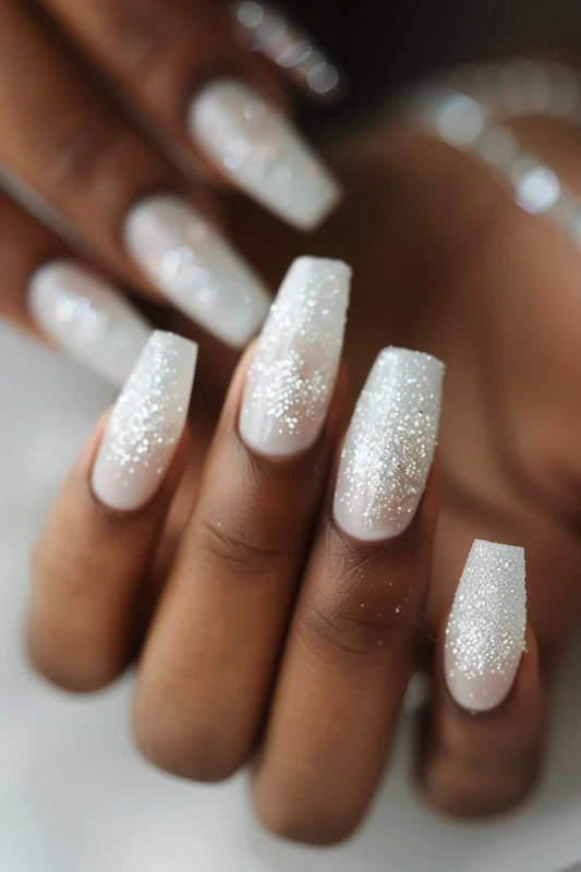 Coffin nails with subtle glitter on a white base.
