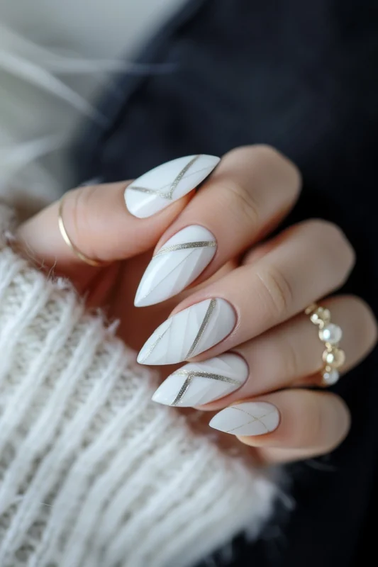 White almond nails with elegant silver striping.