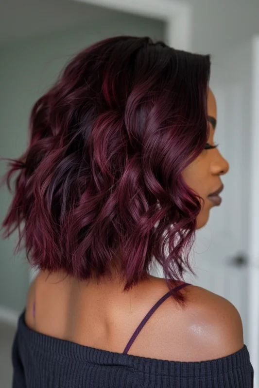 A woman with vibrant deep red hair flowing in waves.