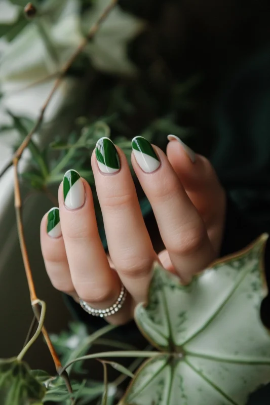 Diagonal green French tip nails on a nude base.