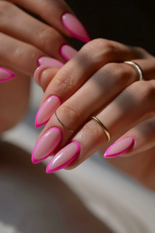 Hot pink French tip nails with a soft pink base.