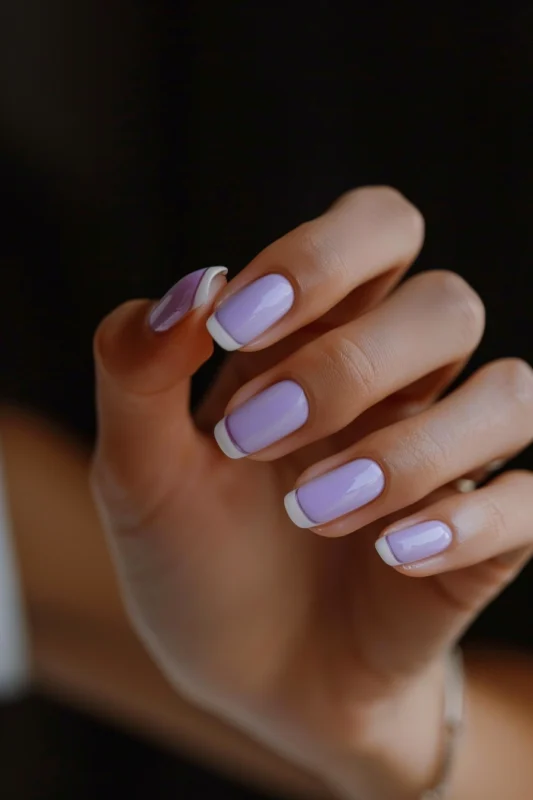 White French tip nails with a creamy lavender base.