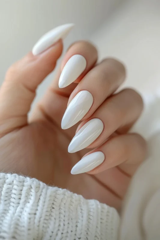 Glossy, milky white almond-shaped nails.