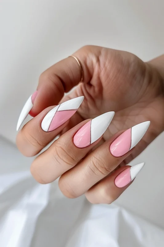 Geometric white and pink nails with sharp angular lines.