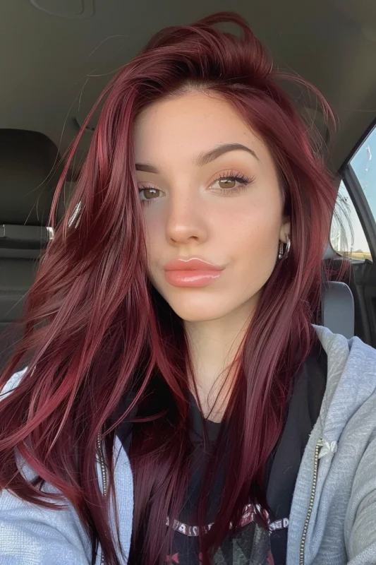 A woman with deep red violet colored hair