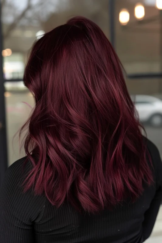 A woman with elegant red wine-colored hair.