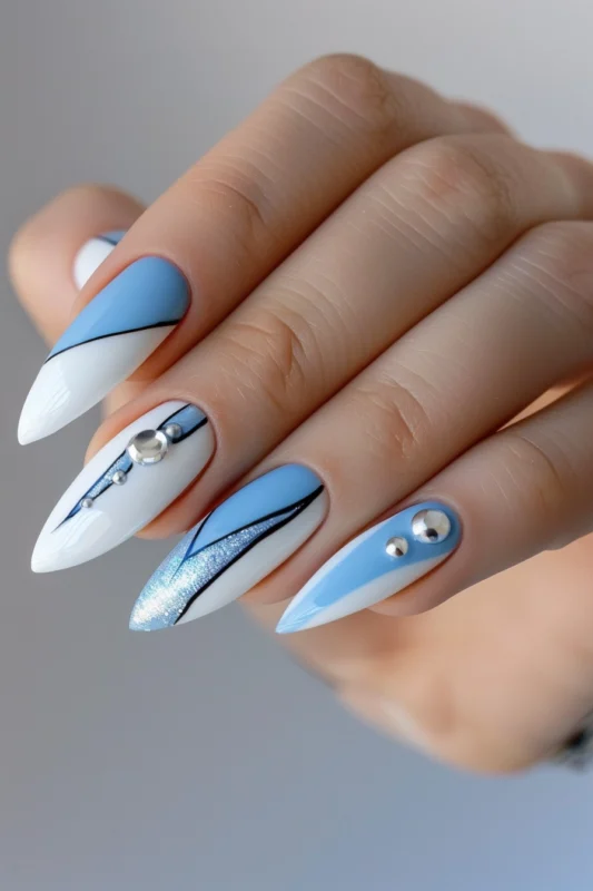 Stiletto nails with baby blue and white design.