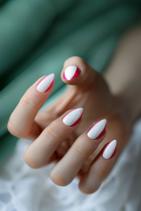 White almond-shaped nails with a hot pink border.