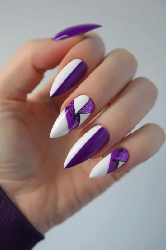 White stiletto nails with bold purple accents and glitter details.