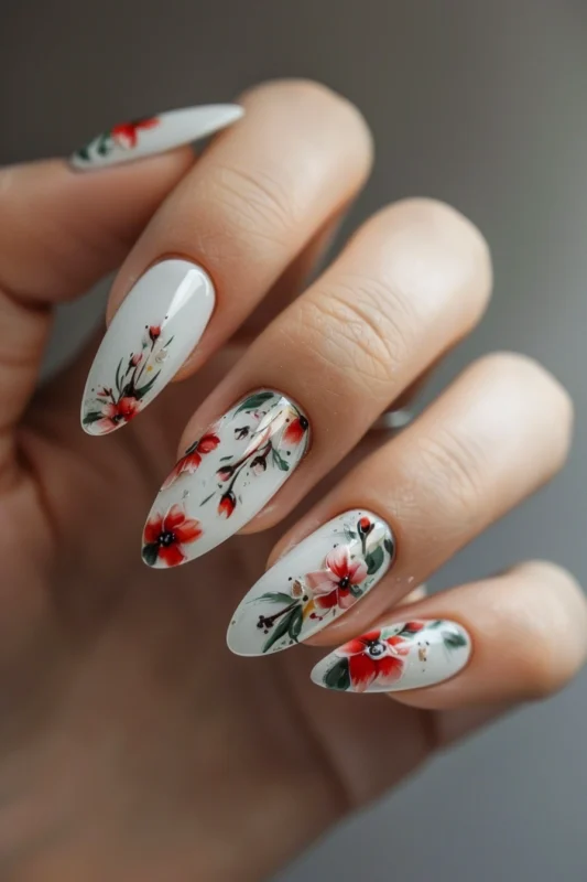 White nails with red, pink, and green floral details.