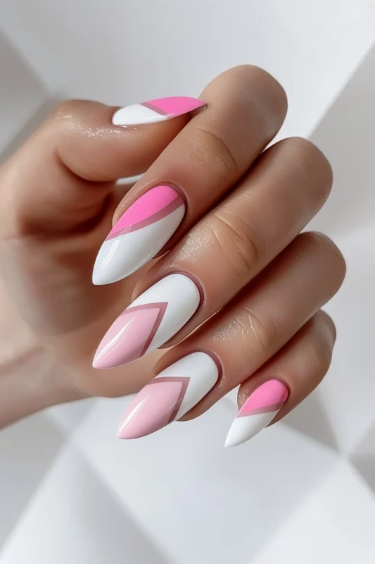 Stiletto nails with geometric white and pink design.
