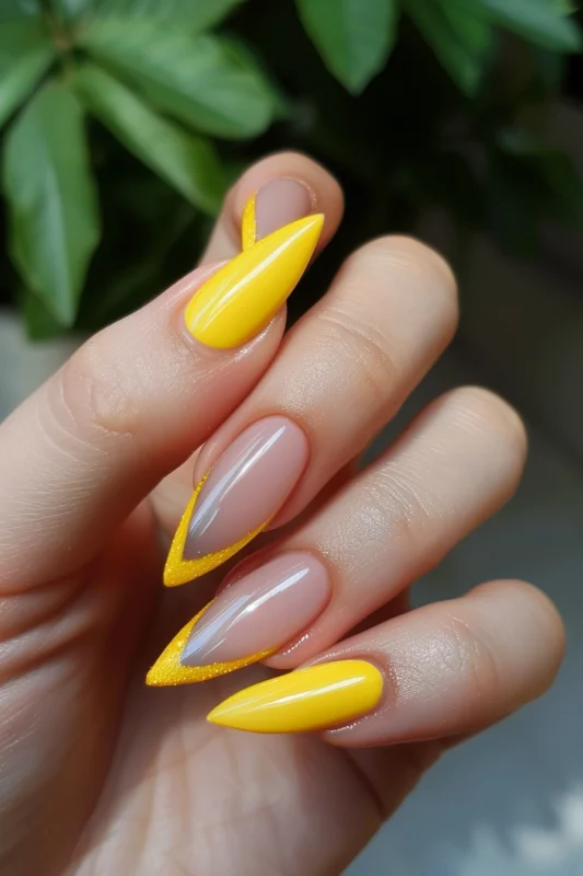 Yellow French tips on long pointed nails.