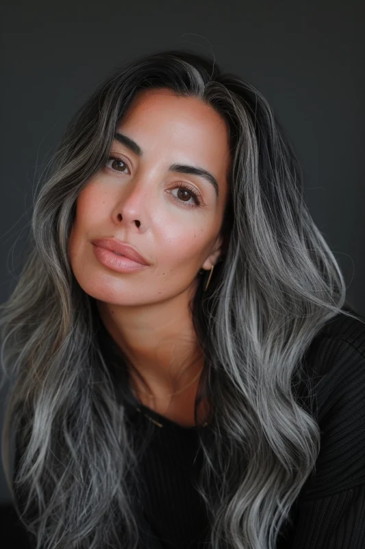 Woman with sleek salt and pepper hair.