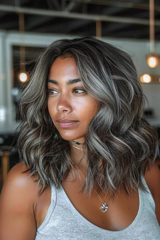 A woman with beautifully blended silver and dark hair.