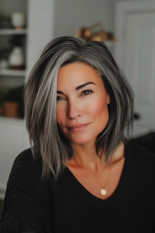 Woman with strong salt and pepper hair contrast.