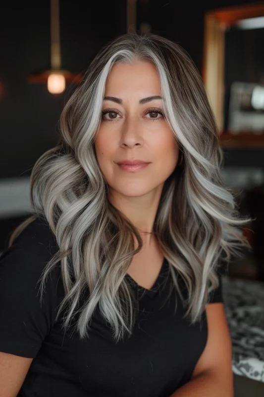 Woman with glamorous salt and pepper highlights.