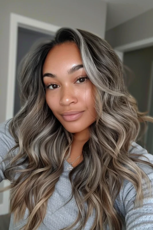 Dynamic silver and gray highlights in brown curly hair.
