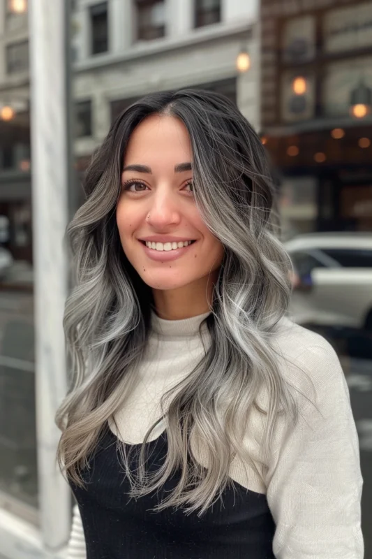 Woman with dark to gray ombre hair.