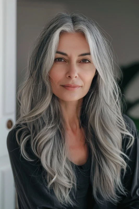 A woman with luxurious long salt and pepper hair.
