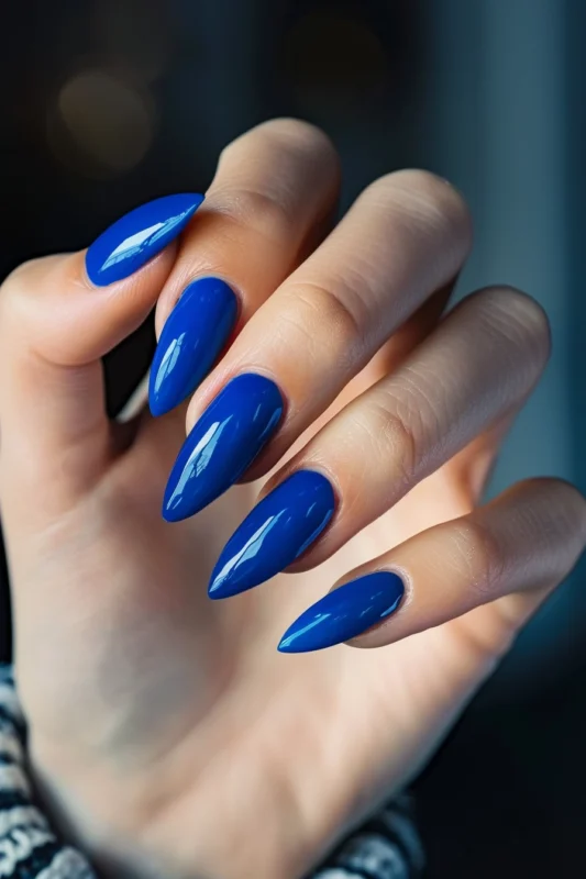 Glossy navy blue stiletto nails.