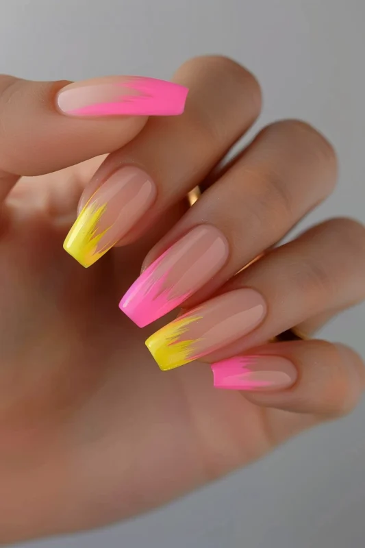 Nails with a neon pink and neon yellow gradient.