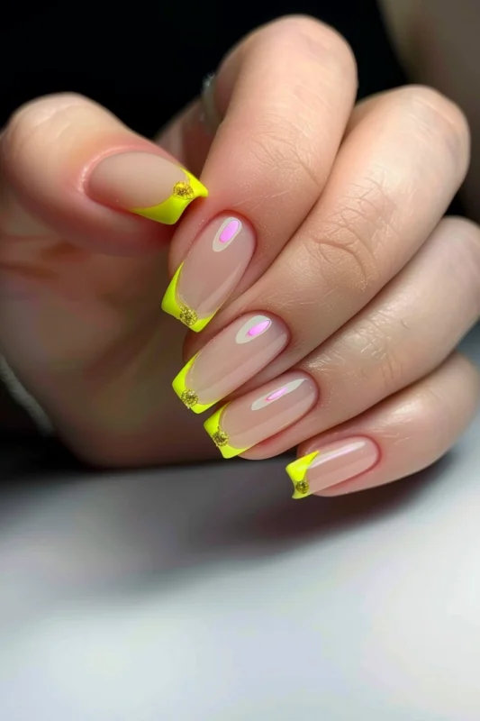 Neon yellow French tips on square nails with gold gems.