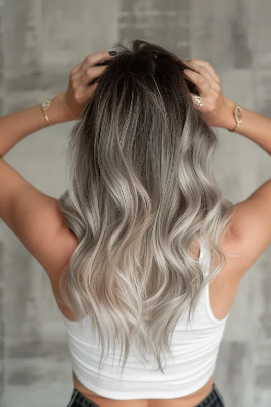 Woman with long platinum silver ombre hair.