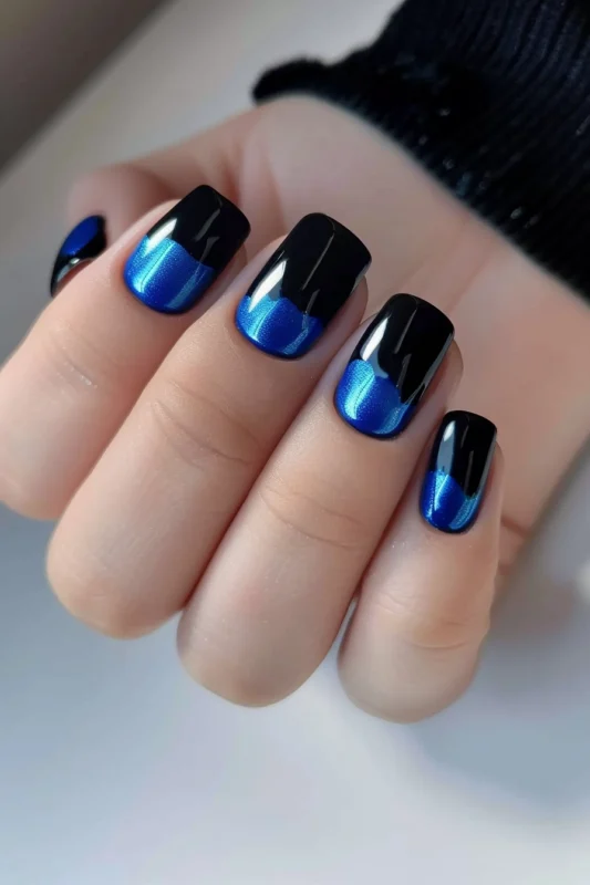 Royal blue nails with a black gradient effect.