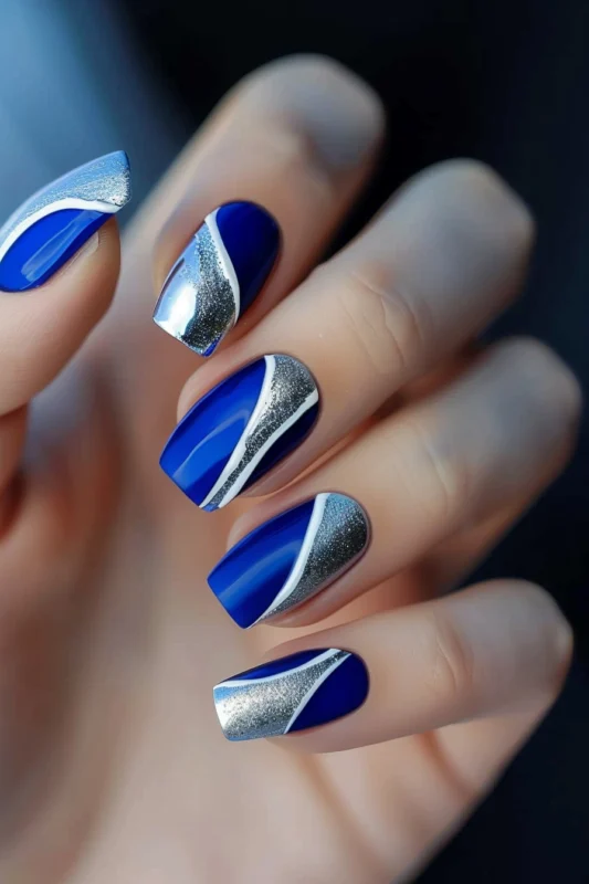 Royal blue nails with silver glitter crescents.