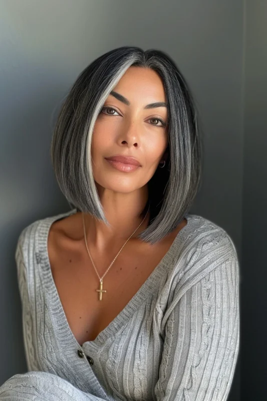 A woman with a sleek salt and pepper bob hairstyle.