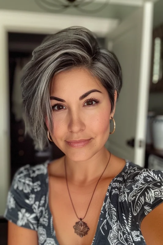 A woman with shiny, wavy salt and pepper hair.