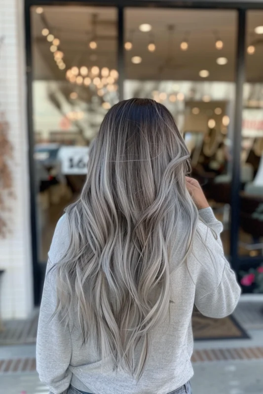 Back view of a woman with silver balayage hair.