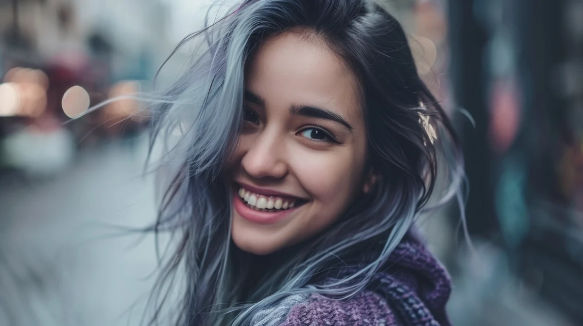 Young woman with silver highlights in dark hair.