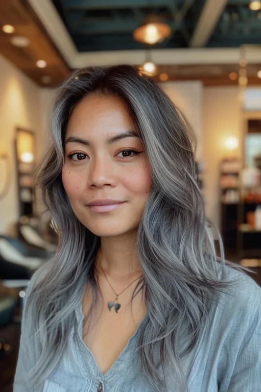 Woman with full silver highlights on dark hair.