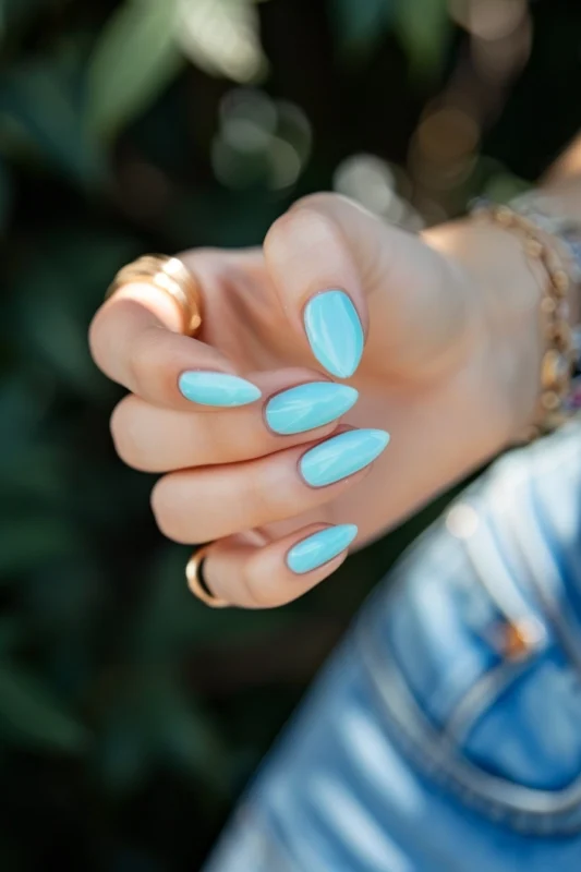 Sleek almond-shaped nails in Tiffany blue.