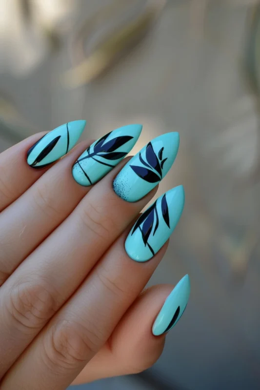 Almond nails in Tiffany blue with black botanical designs.