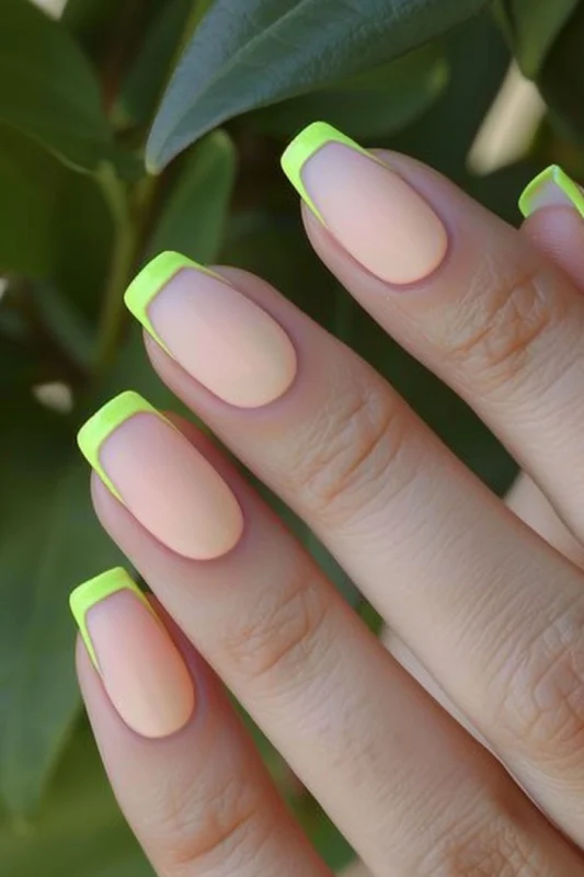 Coffin-shaped nails with bright yellow French tips.