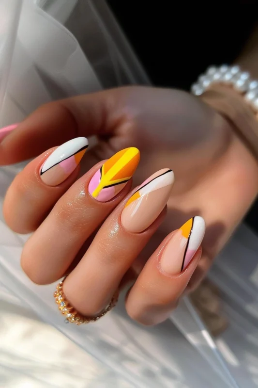 Geometric nail art with yellow, white, and pink accents