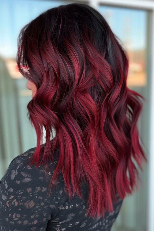 Woman with dark hair and vivid raspberry red tips.
