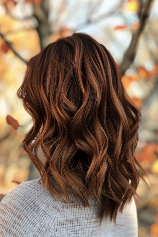 Woman with reddish brown hair and subtle blonde highlights.